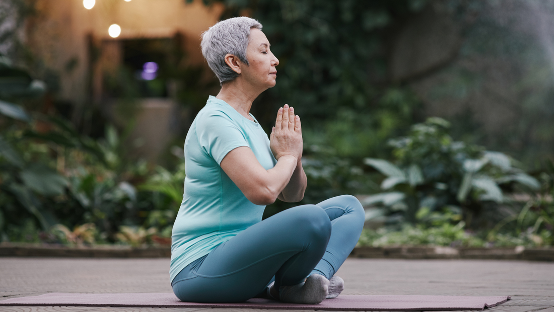 Older women sitting in Easy Pose while quietly meditating